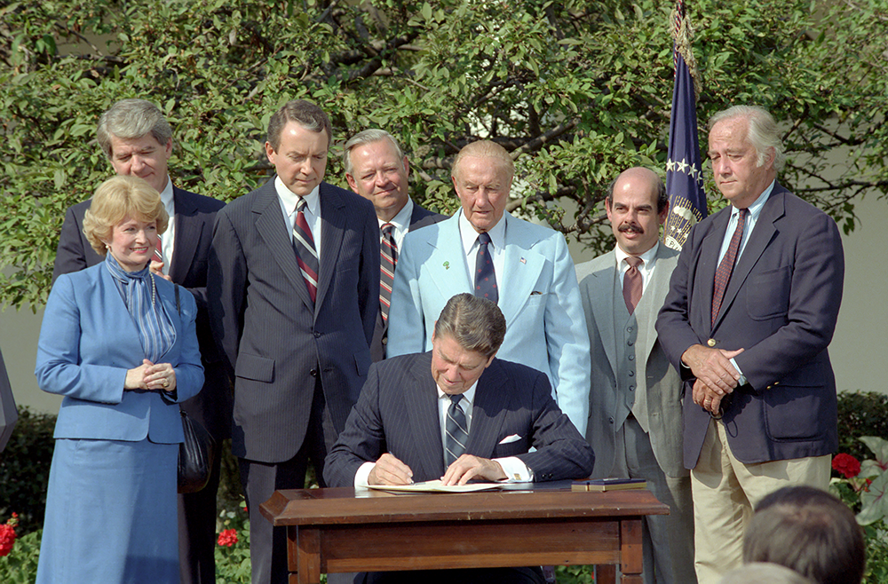 Rep. Waxman [second from right] looks on as President Reagan signs the Drug Price Competition and Patent Term Restoration Act. White House Rose Garden; September 24, 1984.
