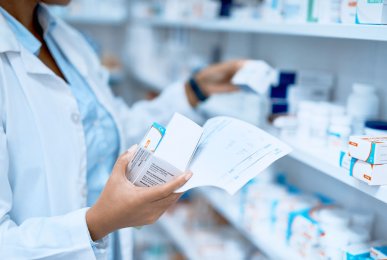 Cropped shot of a pharmacist filling a prescription at a chemist