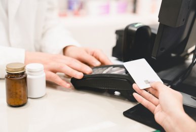 Closeup cashless wireless payment with credit card at the pharmacy