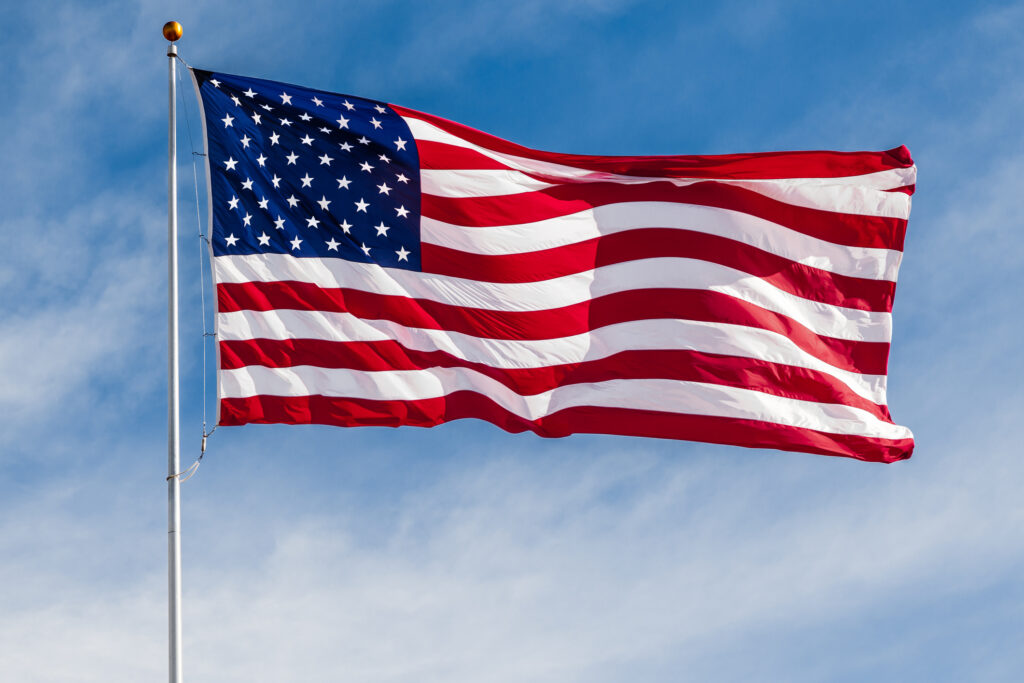 American flag waving against blue sky