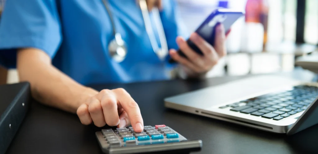 Medical Professional using a calculator.