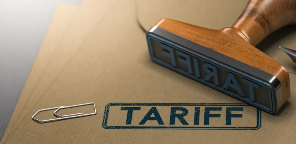 A rubber stamp with the word tariff stamped on paper background